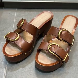 Veronica Beard brown and golden colored rivet clogs.